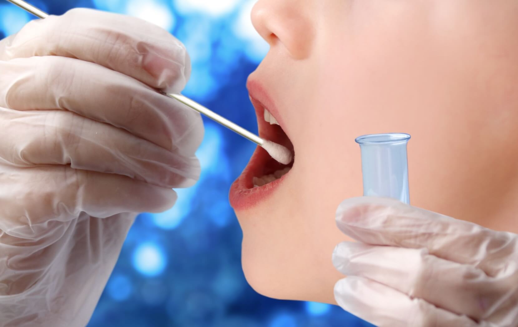 A dentist uses a cotton swab to collect a saliva sample from the inside of their patient's mouth for saliva testing.