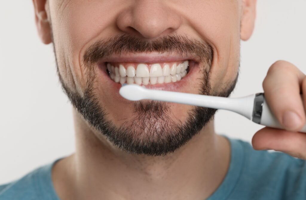 Close-up of someone's mouth as they're brushing their teeth.